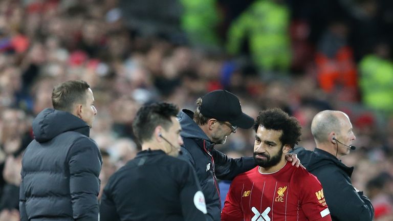 Mohamed Salah speaks with Jurgen Klopp as he is substituted