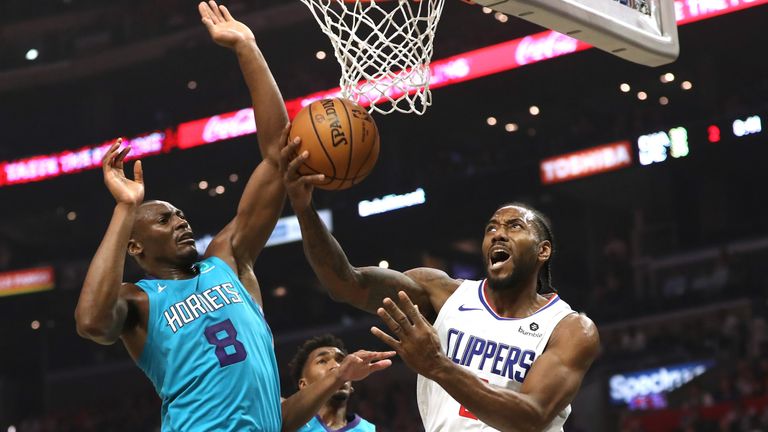 Kawhi Leonard attempts to escape the defensive attentions of Bismack Biyombo beneath the basket