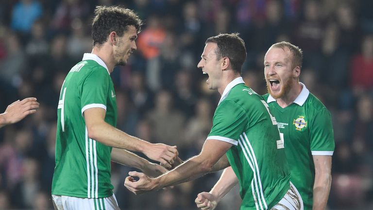 Northern Ireland's defender Jonny Evans (c) celebrates with his teammates after scoring during the international friendly football match between Czech Republic and Northern Ireland in Prague, on October 14, 2019. (Photo by Michal CIZEK / AFP) (Photo by MICHAL CIZEK/AFP via Getty Images)