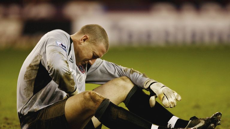 Paddy Kenny lies injured during the win over Arsenal, with the Blades 1-0 up