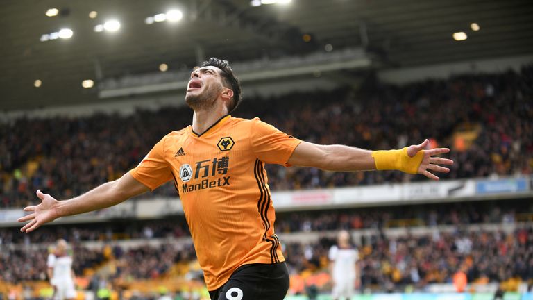 Raul Jimenez celebrates with arms outstretched after converting his penalty