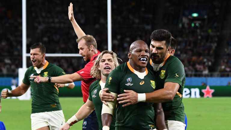 Bongi Mbonambi (middle) is congratulated after scoring South Africa's second try against Italy