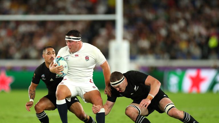Jamie George is tackled by New Zealand lock Brodie Retallick (right) and Aaron Smith