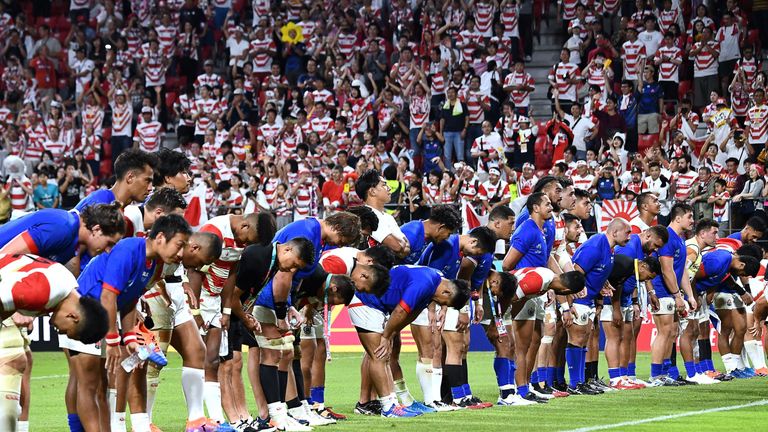 Japan and Samoa players bow after their Rugby World Cup match