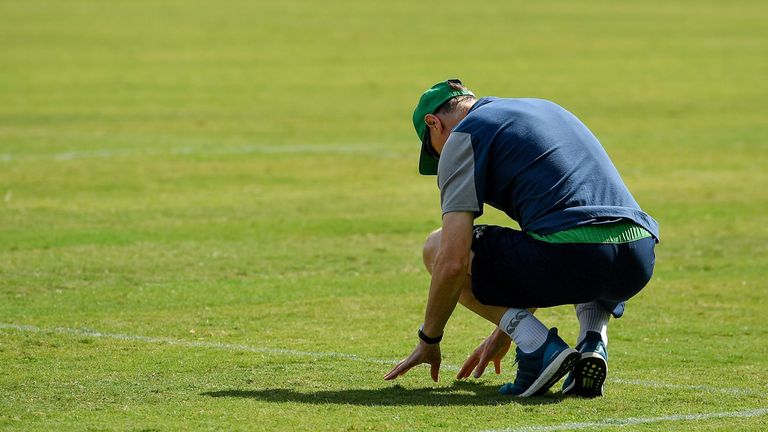 Ireland head coach Joe Schmidt checks the state of the pitch at the Fukuoka Hakatanomori Stadium
