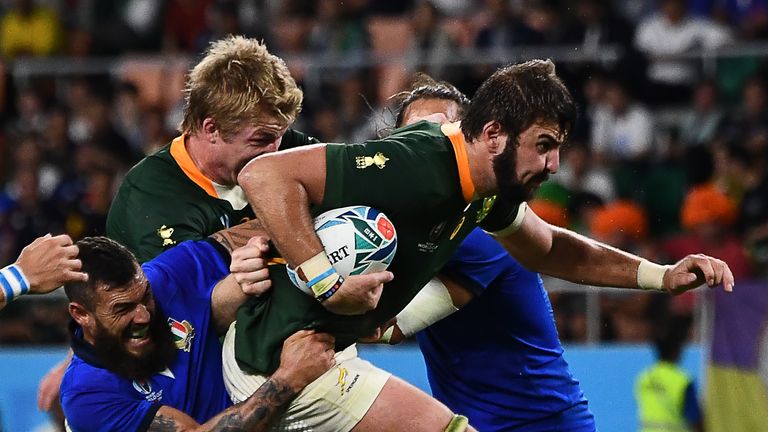 South Africa's Lood de Jager is tackled by Jayden Hayward of Italy