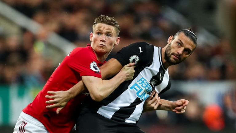 Scott McTominay grapples with Andy Carroll 