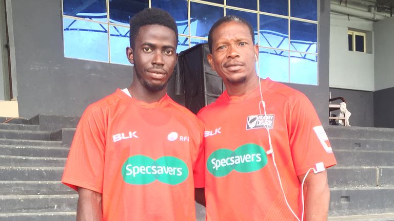 Two match officials from Sierra Leone with donated shirts