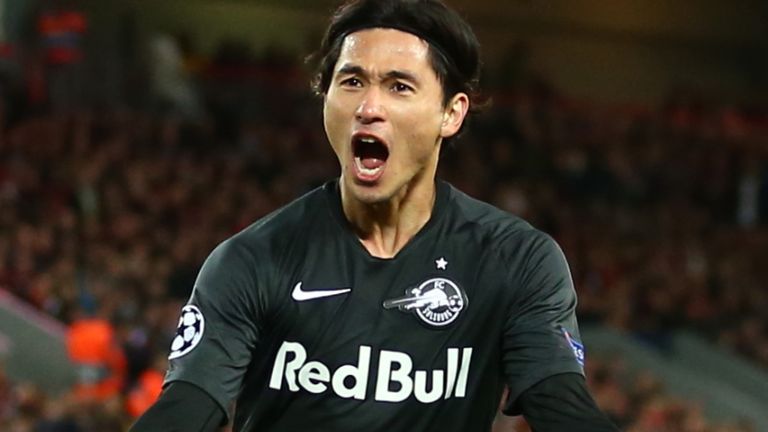 Takumi Minamino celebrates hauling back another Salzburg night on a balmy night at Anfield