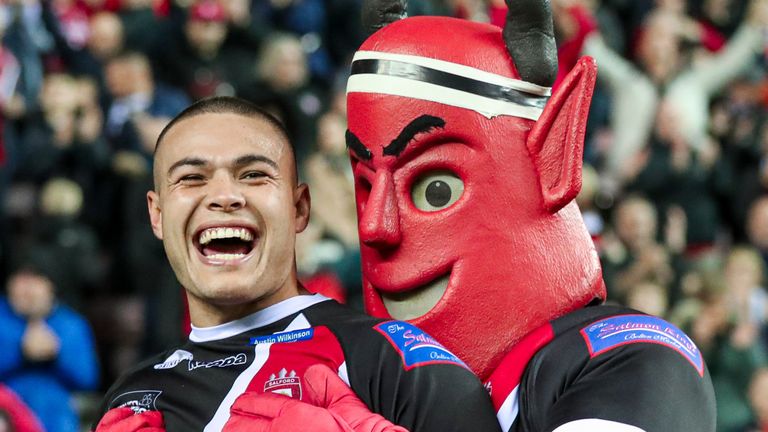 Picture by Alex Whitehead/SWpix.com - 04/10/2019 - Rugby League - Betfred Super League Play-off Semi Final - Wigan Warriors v Salford Red Devils - DW Stadium, Wigan, England - Salford's Tui Lolohea and the mascot celebrate the win.