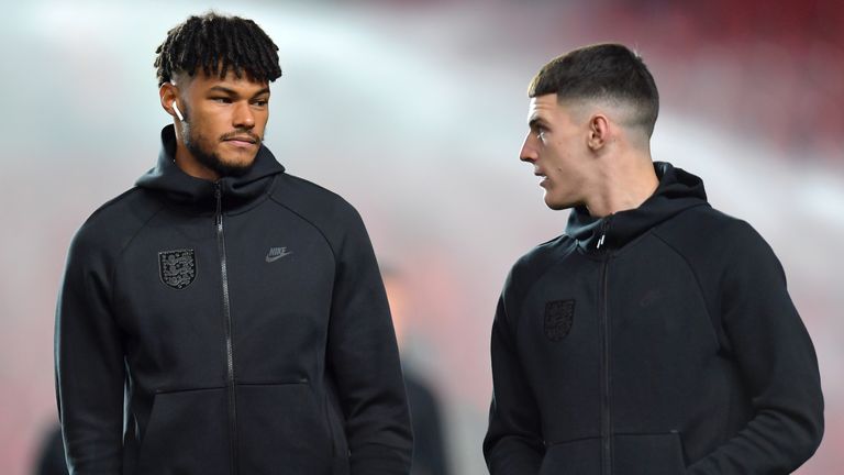 Tyrone Mings pictured in England training kit inspecting the pitch ahead of Czech Republic game