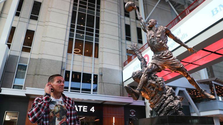 Usyk with Michael Jordan's statue at the home of the Chicago Bulls