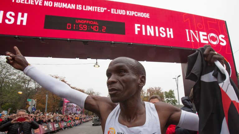 Kenya's Eliud Kipchoge (white jersey) celebrates after busting the mythical two-hour barrier for the marathon on October 12 2019 in Vienna. - Kenya's Eliud Kipchoge on Saturday made history, busting the mythical two-hour barrier for the marathon on a specially prepared course in a huge Vienna park. With an unofficial time of 1hr 59min 40.2sec, the Olympic champion became the first ever to run a marathon in under two hours.