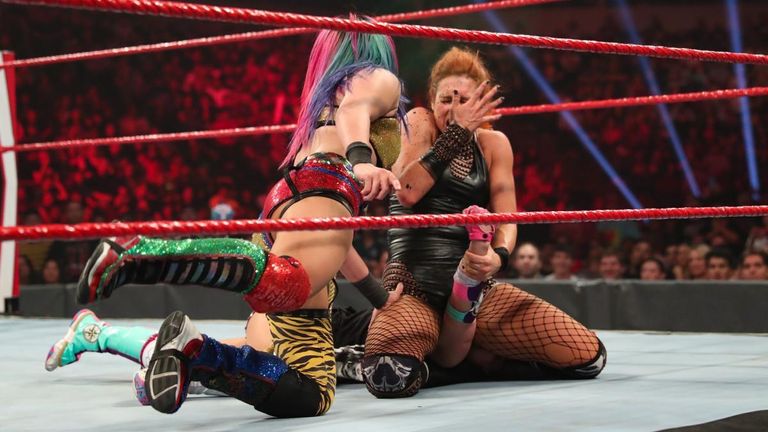 becky lynch gets sprayed with green mist by asuka