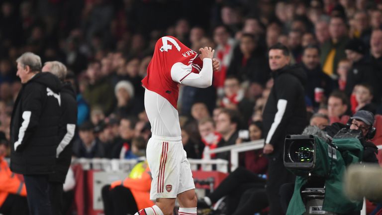 The Switzerland international removes his shirt as he trudges off the field