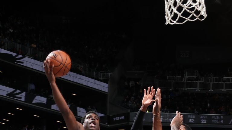 Aaron Holiday attacks the basket against Brooklyn