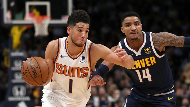 Devin Booker drives by Gary Harris