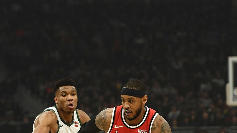 Carmelo Anthony drives by Giannis Antetokounmpo