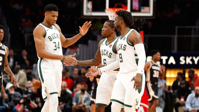Giannis Antetokounmpo congratulates team-mates Eric Bledsoe and Wes Matthews