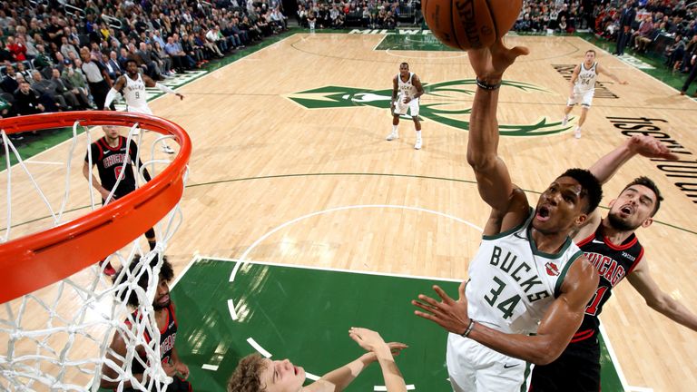 Giannis Antetokounmpo finishes at the rim against the Bulls