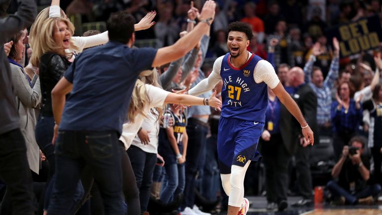 Jamal Murray celebrates a basket with the Nuggets fans at courtside
