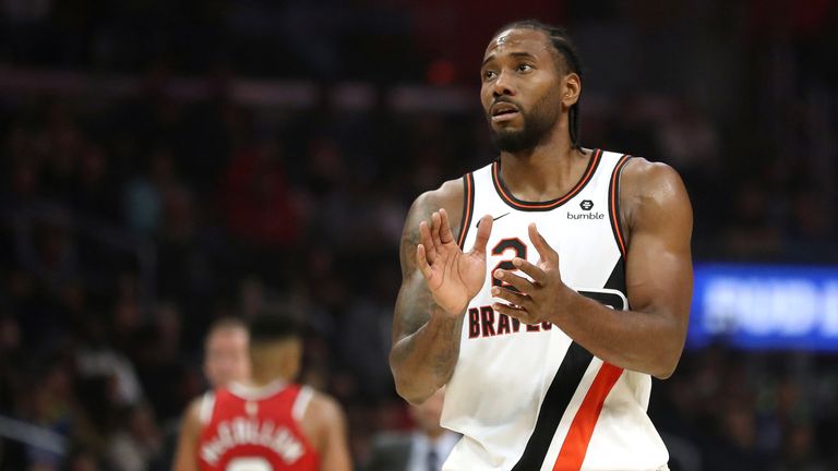 Kawhi Leonard applauds his team-mates during the Clippers&#39; victory over the Trail Blazers.