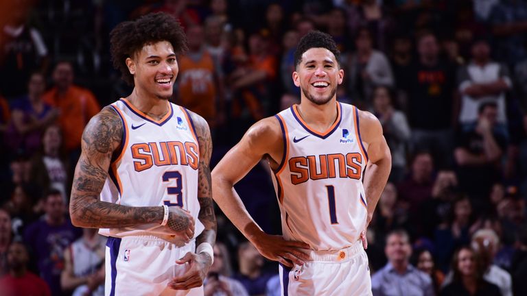 Kelly Oubre Jr and Devin Booker pictured in good spirits during a Phoenix Suns game