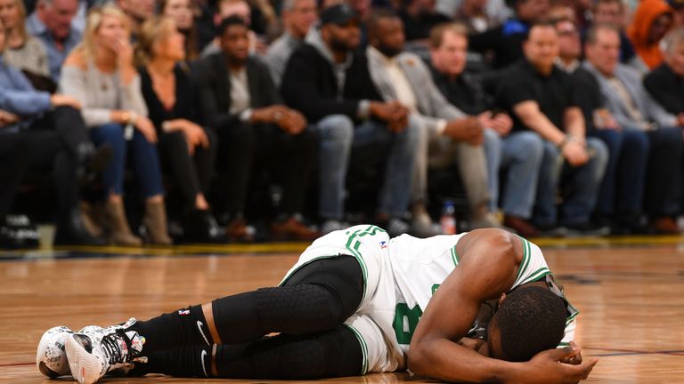 Kemba Walker lays on the court after colliding with team-mate Semi Ojeleye