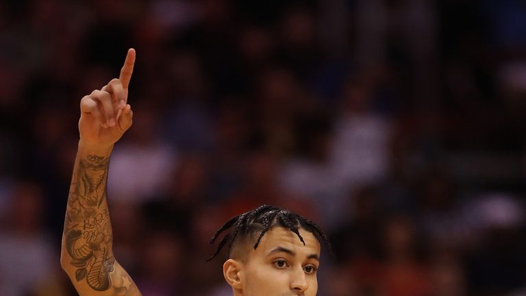 Kyle Kuzma salutes the crowd after draining a three-pointer