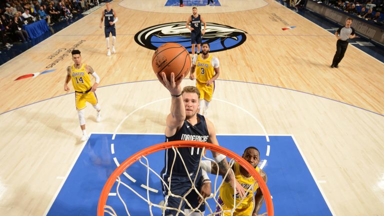 Luka Doncic finishes at the rim against the Lakers