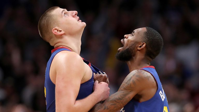 Nikola Jokic is congratulated by team-mate Will Barton after hitting a late game-winner against Philadelphia
