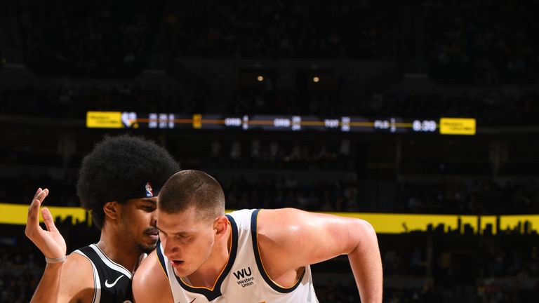 Nikola Jokic is guarded by Jarrett Allen