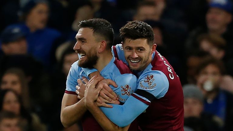 West Ham United's English defender Aaron Cresswell (R) celebrates with West Ham United's Scottish midfielder Robert Snodgrass after he scores his team's first goal during the English Premier League football match between Chelsea and West Ham United at Stamford Bridge in London on November 30, 2019. 