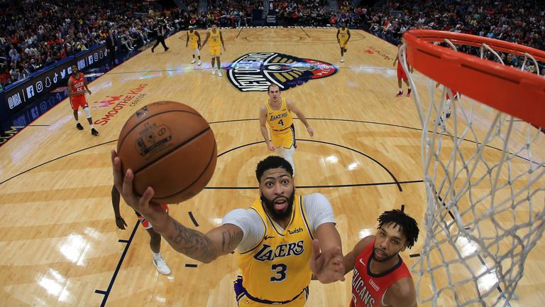 Anthony Davis flies past Jahlil Okafor to the rim for the Lakers against the Pelicans