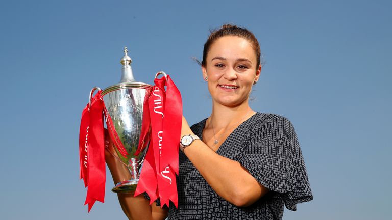 Ashleigh Barty holds the Billie Jean King trophy after ending the season in style