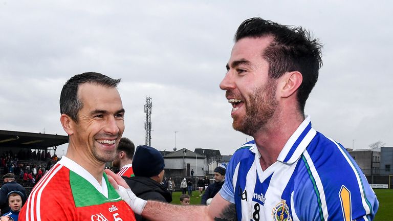 Michael Darragh Macauley of Ballyboden St Endas and Dessie Dolan of Garrycastle embrace after the game