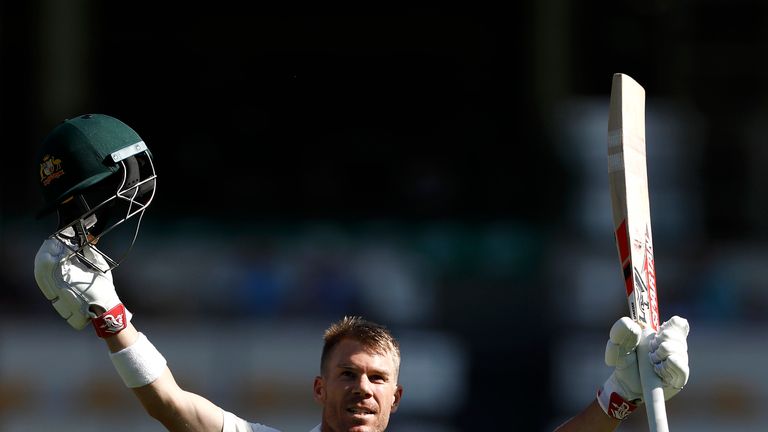 Australia's David Warner raises his bat after reaching a century in the first Test against Pakistan at Brisbane