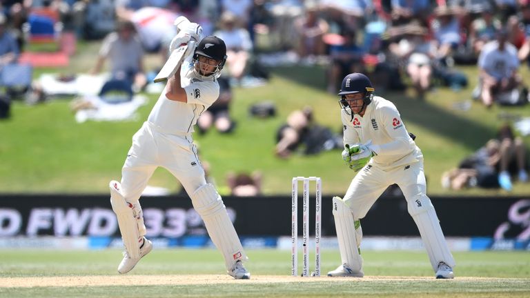 England wicketkeeper Jos Buttler looks on as Mitchell Santner piles on the runs for New Zealand