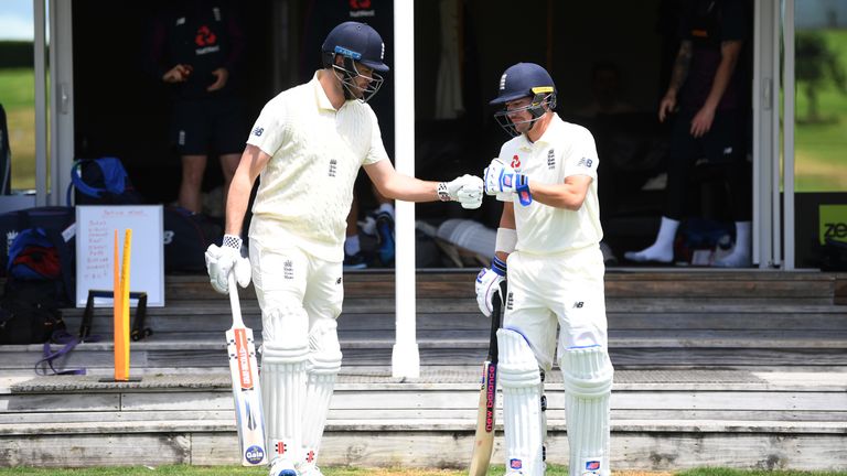 Dom Sibley (L) and Rory Burns walk out to bat in England's warm-up match against a New Zealand XI in Whangarei