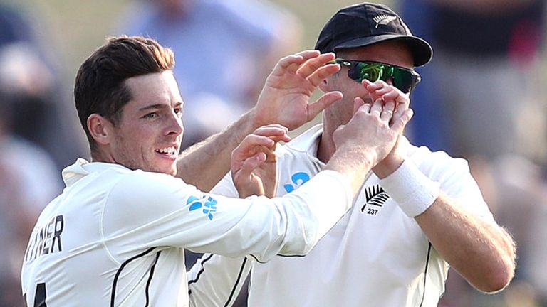 New Zealand's Mitchell Santner celebrates the wicket of Rory Burns in the first Test against England