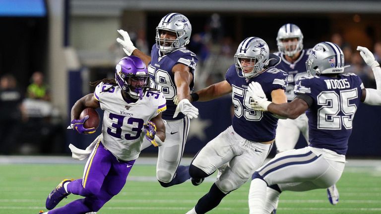Dalvin Cook of the Minnesota Vikings runs against the Dallas Cowboys including Leighton Vander Esch and Xavier Woods