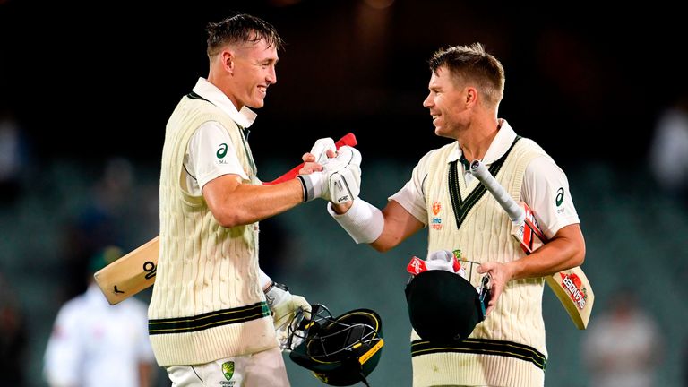 Australian batsmen Marnus Labuschagne (L) and David Warner (R) congratulate each other after their partnership against Pakistan on the first day of the second cricket Test match in Adelaide on November 29, 2019.
