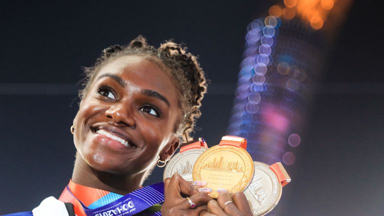 Britain's Dina Asher-Smith poses with her gold medal for the Women's 200m, silver medal for the Women's 100m and silver medal for the Women's 4x100m Relay during the medal ceremony at the 2019 IAAF Athletics World Championships at the Khalifa International stadium in Doha on October 6, 2019. (