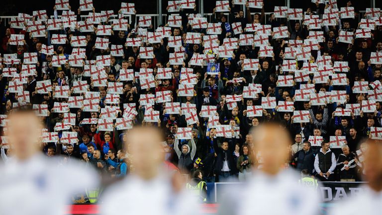 Kosovo fans hold up England flags as England's anthem 'God save the queen' is being played during the UEFA Euro 2020 qualifying Group A football match between Kosovo and England at the Fadil Vokrri stadium in Prishtina 