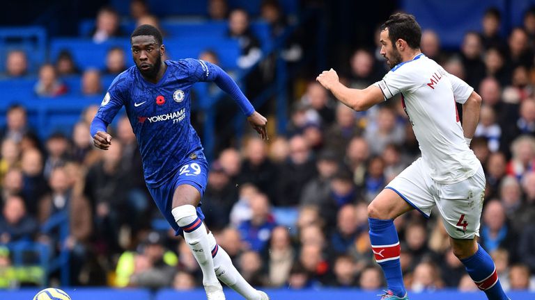Fikayo Tomori runs with the ball under pressure from Luka Milivojevic