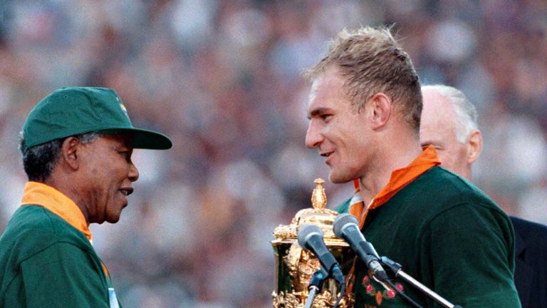 Francois Pienaar receives the Rugby World Cup from Nelson Mandela in 1995