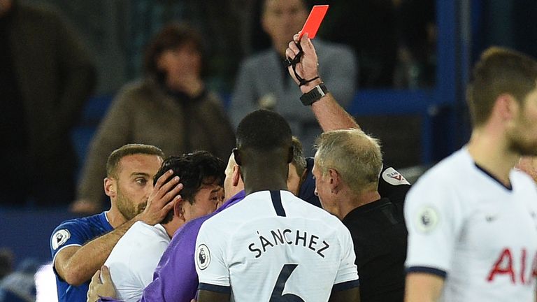 Referee Martin Atkinson shows Heung-min Son a red card following his challenge on Everton's Andre Gomes