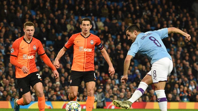 Manchester City's German midfielder Ilkay Gundogan shoots to score the opening goal during the UEFA Champions League football Group C match between Manchester City and Shakhtar Donetsk at the Etihad Stadium