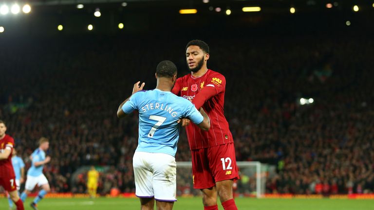 Joe Gomez pushes Raheem Sterling away after the pair squared up at Anfield