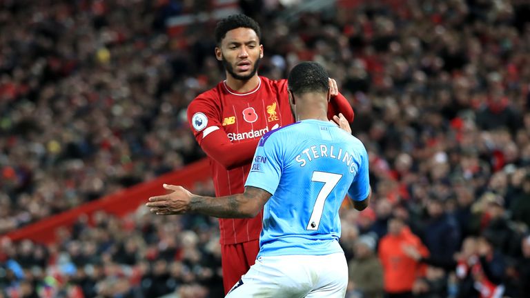 Joe Gomez and Raheem Sterling clash during Liverpool vs Manchester City at Anfield